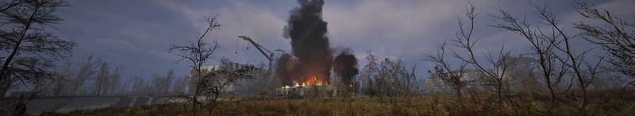 Edificio en llamas con columna de humo a lo lejos