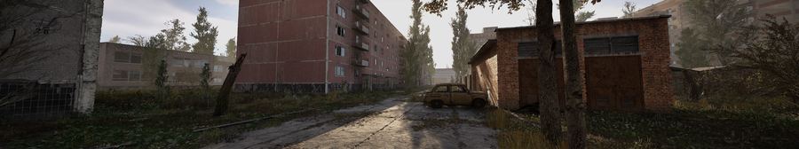 Calle residencial de Prípiat con coche abandonado